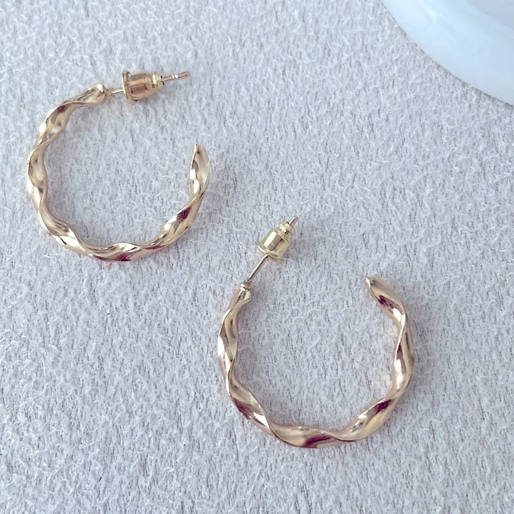 Medium twisted hoop gold earrings